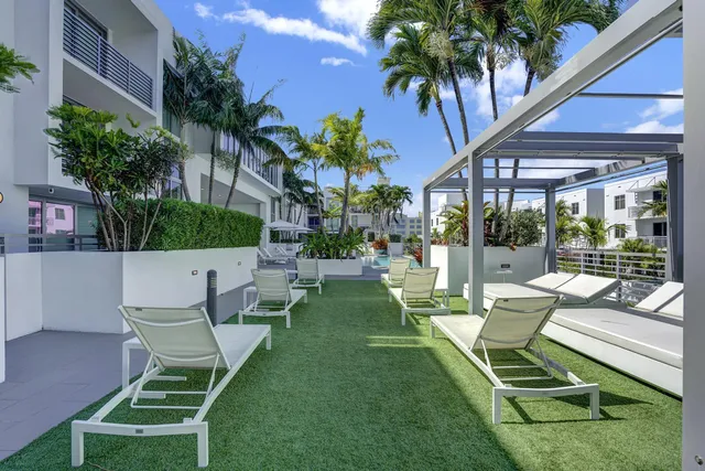 a front view of a building with plants