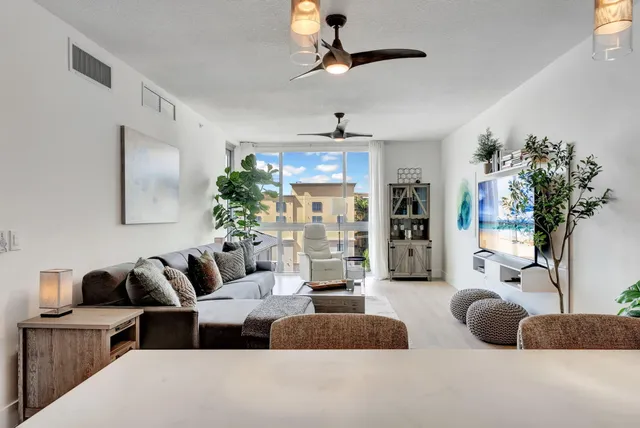 a living room with furniture potted plant and a chandelier
