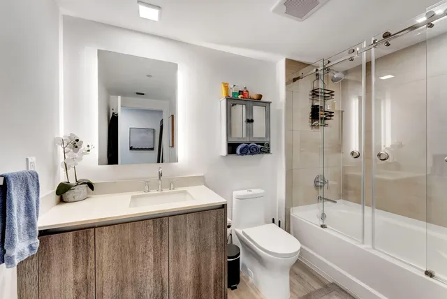 a bathroom with a sink toilet and shower
