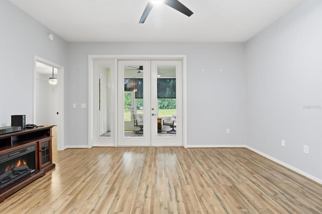 3569 South Belgrave Drive Inverness, FL 34452 - Photo 12 of 70 an empty room with wooden floor and a fireplace