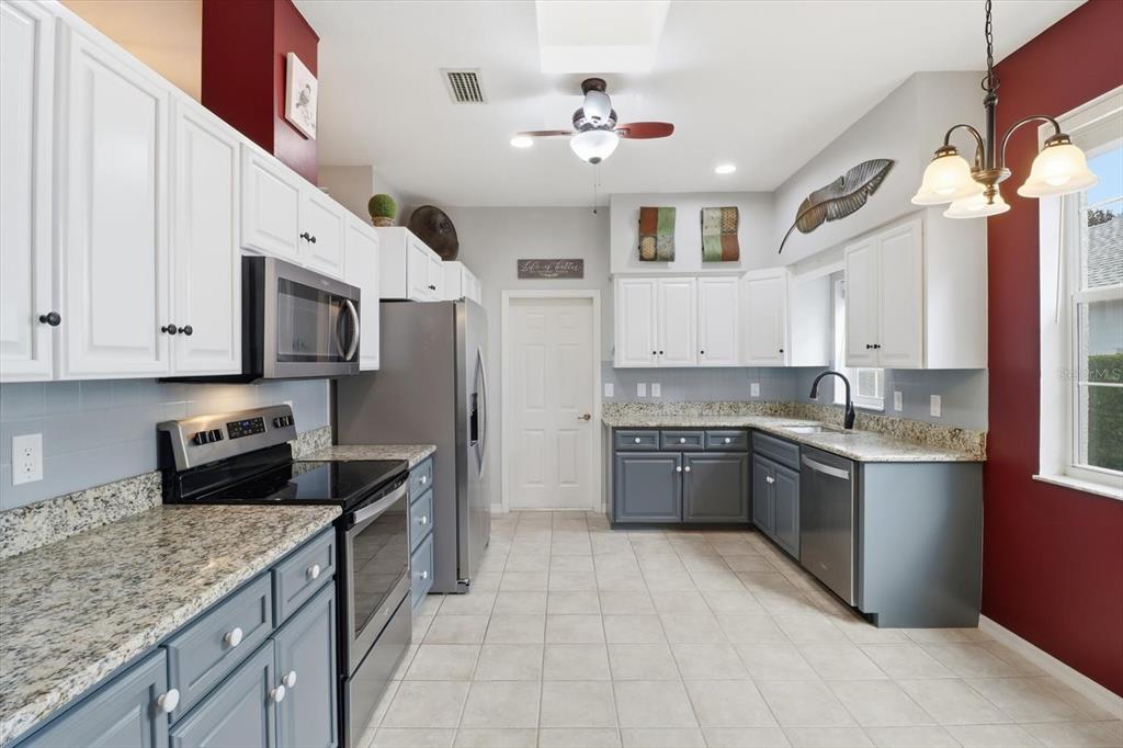 3569 South Belgrave Drive Inverness, FL 34452 - Photo 19 of 70 a kitchen with stainless steel appliances granite countertop a sink and dishwasher a stove top oven with wooden floor