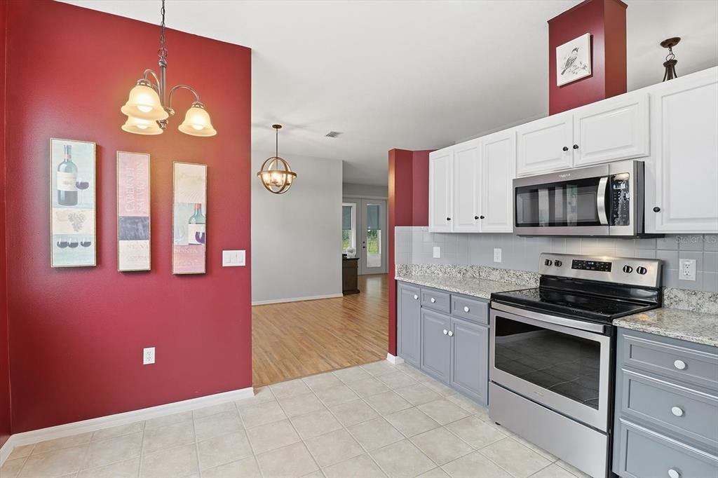 3569 South Belgrave Drive Inverness, FL 34452 - Photo 22 of 70 a kitchen with stainless steel appliances granite countertop a stove cabinets and microwave