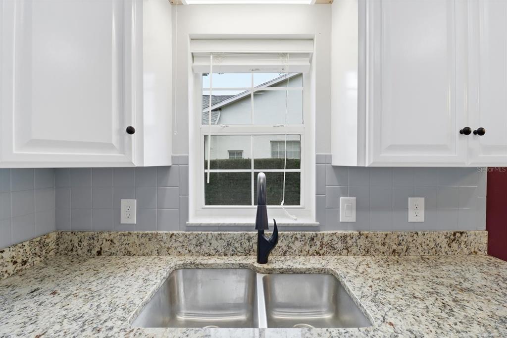3569 South Belgrave Drive Inverness, FL 34452 - Photo 24 of 70 a kitchen with granite countertop a sink and a window