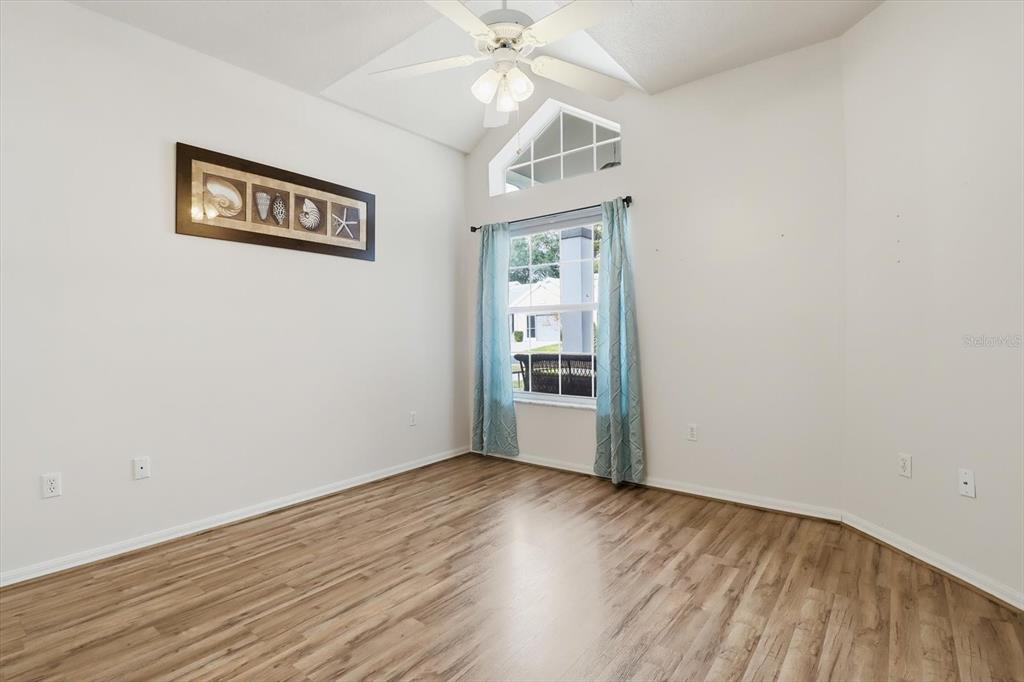 3569 South Belgrave Drive Inverness, FL 34452 - Photo 29 of 70 a view of a hallway with wooden floor and a ceiling fan