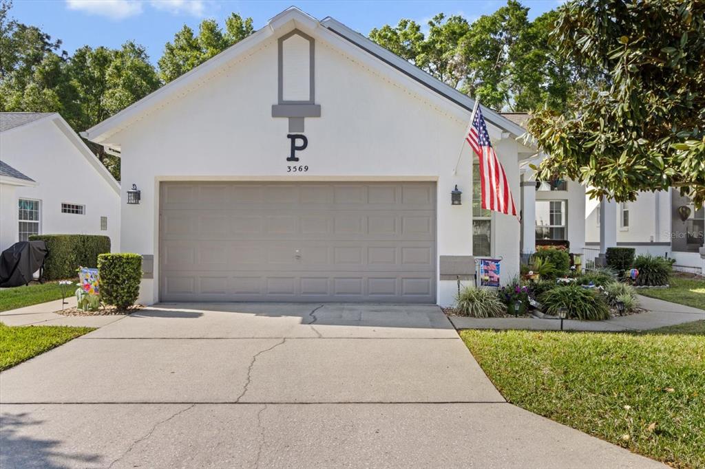 3569 South Belgrave Drive Inverness, FL 34452 - Photo 3 of 70 a front view of a house with a yard