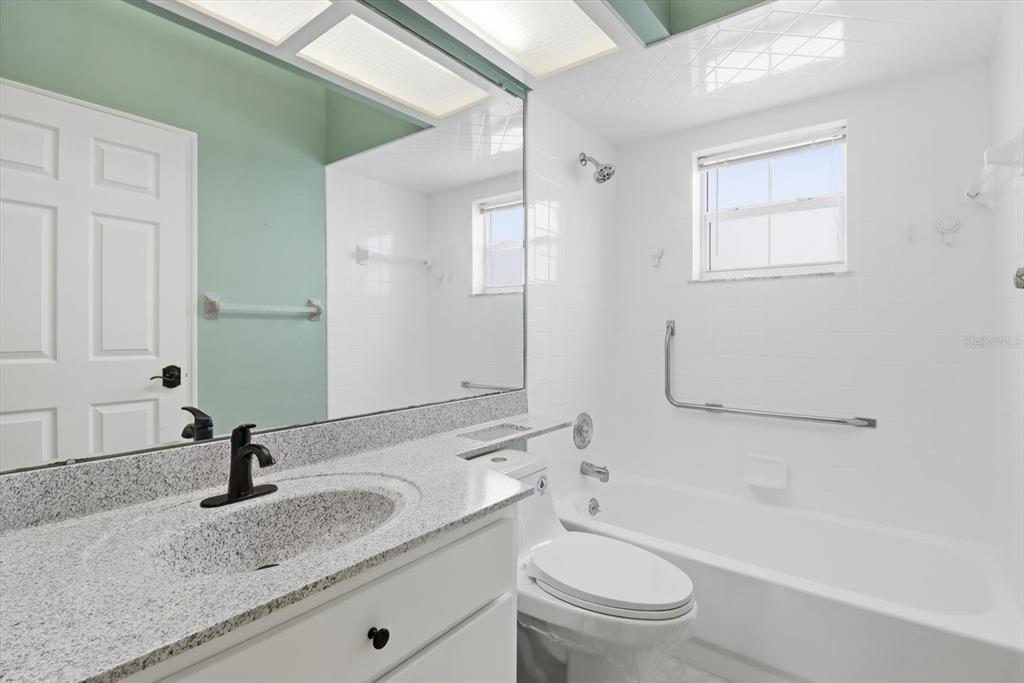 3569 South Belgrave Drive Inverness, FL 34452 - Photo 31 of 70 a bathroom with a granite countertop sink toilet and a mirror