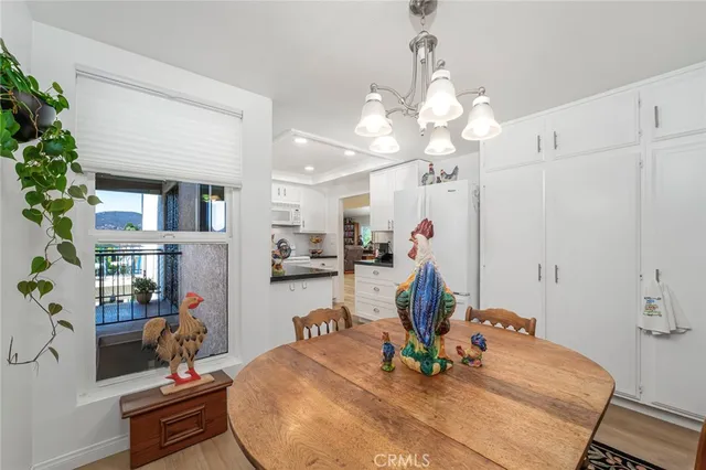 a view of a dining room with furniture and a chandelier