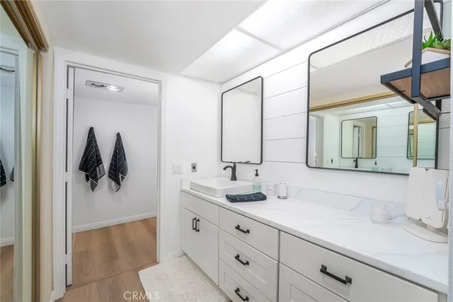 a bathroom with a double vanity sink and mirror