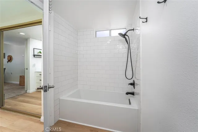 a bathroom with a bathtub and shower