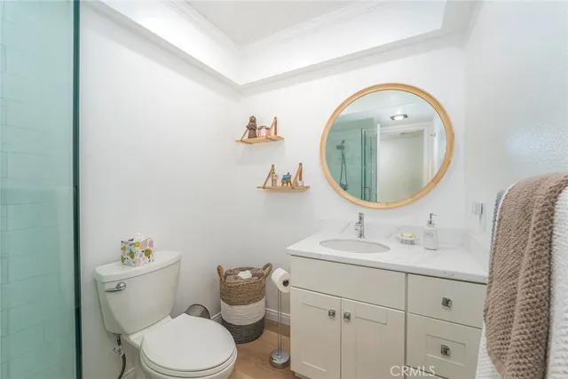 a bathroom with a toilet sink vanity and mirror