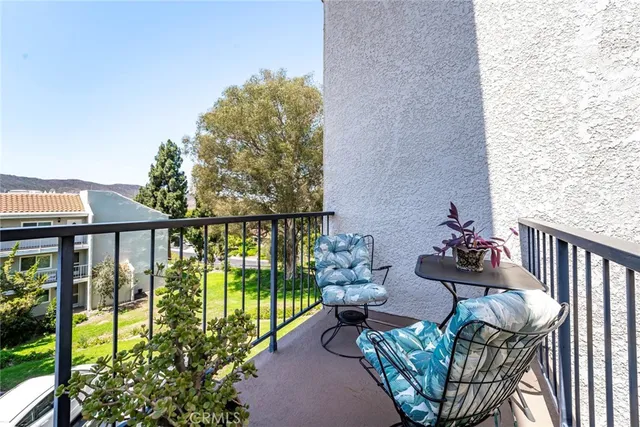 a view of a house with swimming pool next to a yard