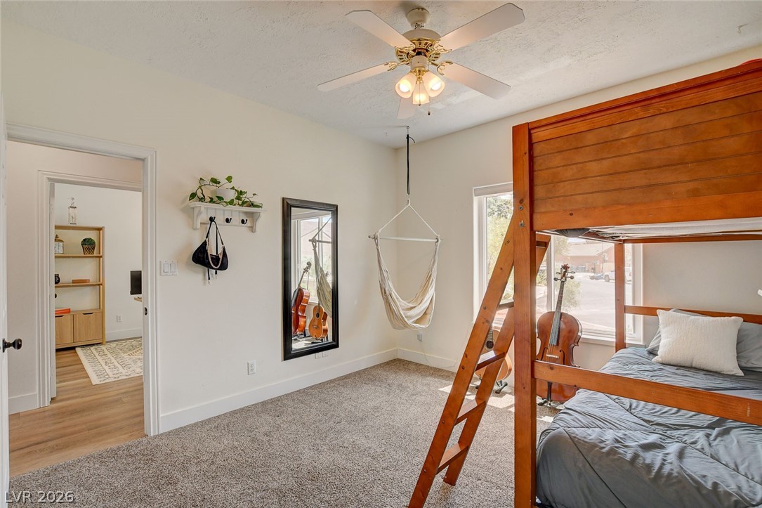4362 Thistle Street Logandale, NV 89021 - Photo 33 of 99 A well-lit bedroom with soft carpet offers a comfortable living space.