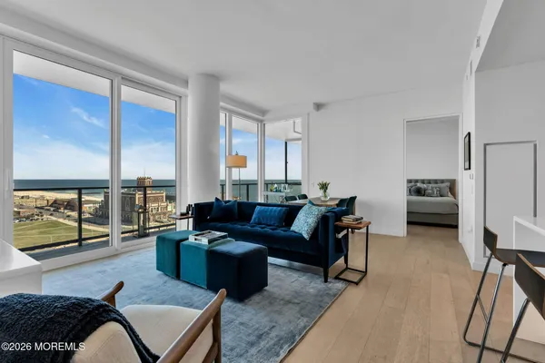 a living room with furniture and a floor to ceiling window