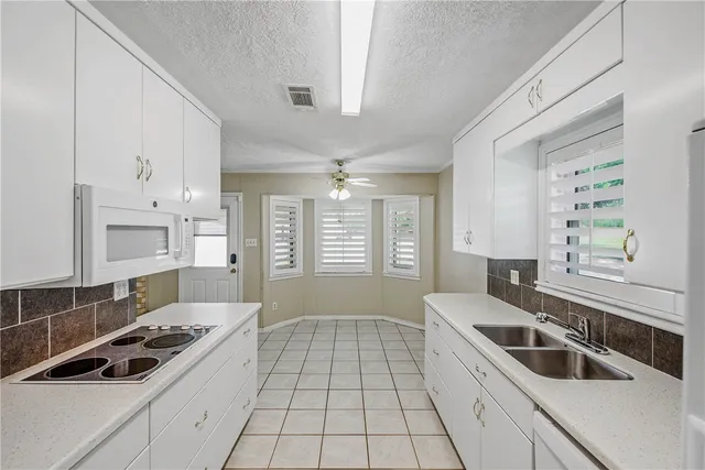 a kitchen that has a sink and a stove