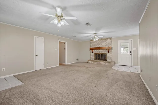 an empty room with a ceiling fan and a window