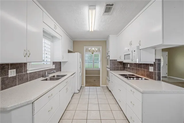 a kitchen with stainless steel appliances a sink stove and cabinets