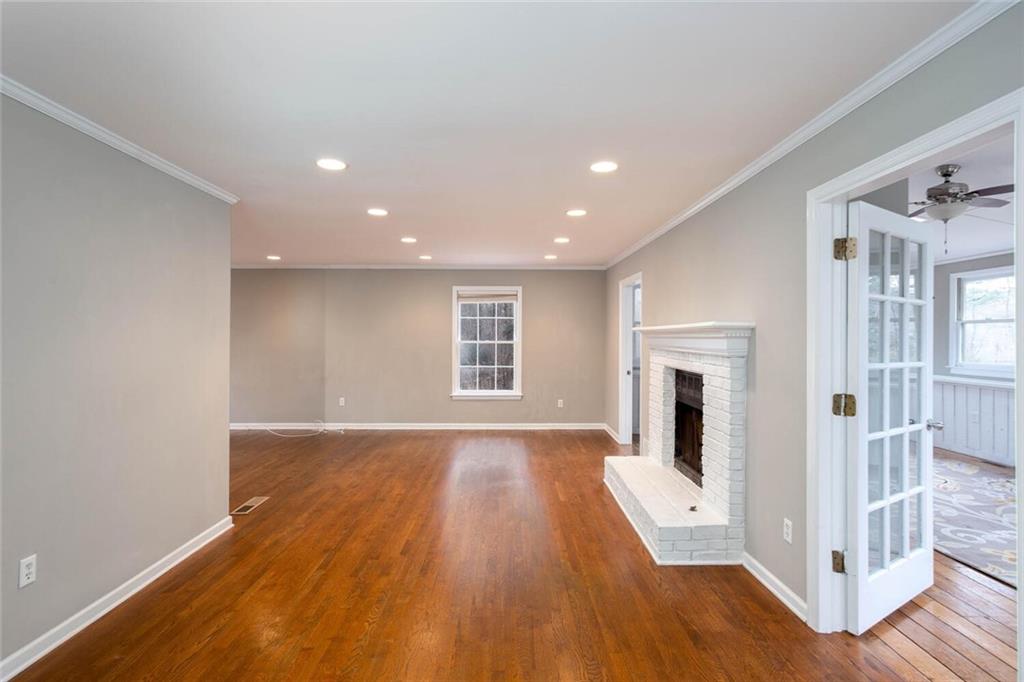 1066 Foreststone Way Marietta, GA 30064 - Photo 12 of 53 a view of empty room with wooden floor and fireplace