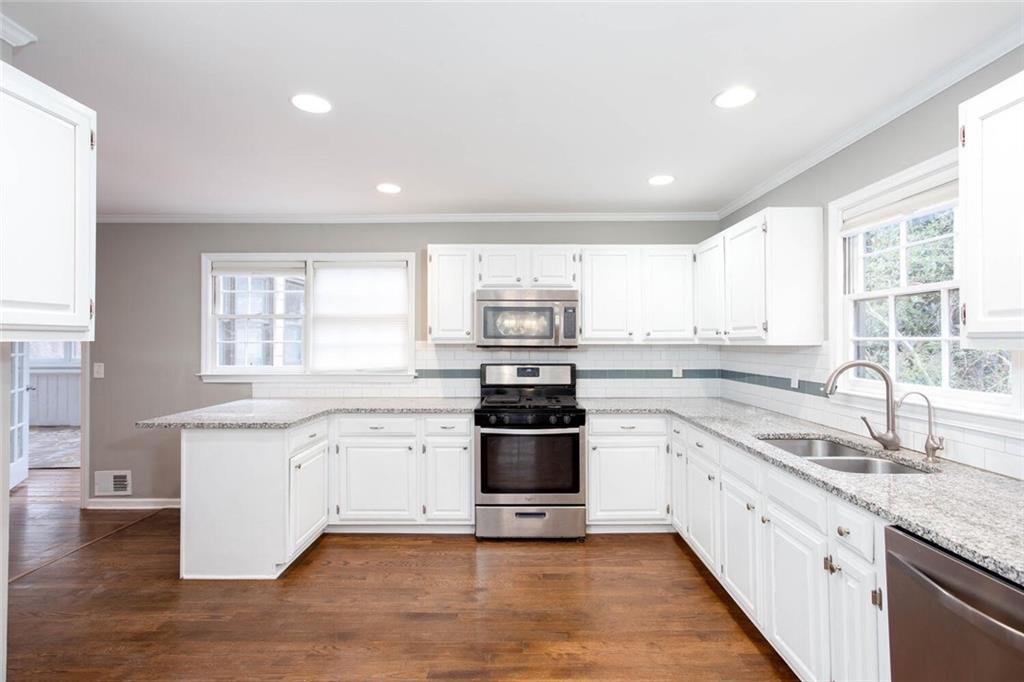 1066 Foreststone Way Marietta, GA 30064 - Photo 15 of 53 a large kitchen with stainless steel appliances granite countertop a stove and a sink