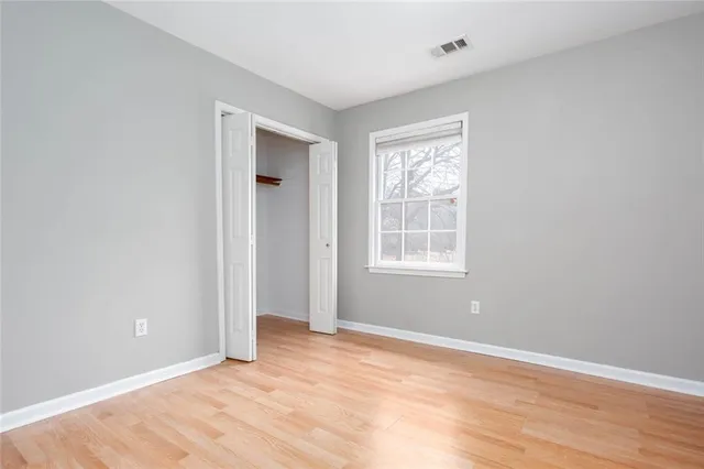 an empty room with wooden floor