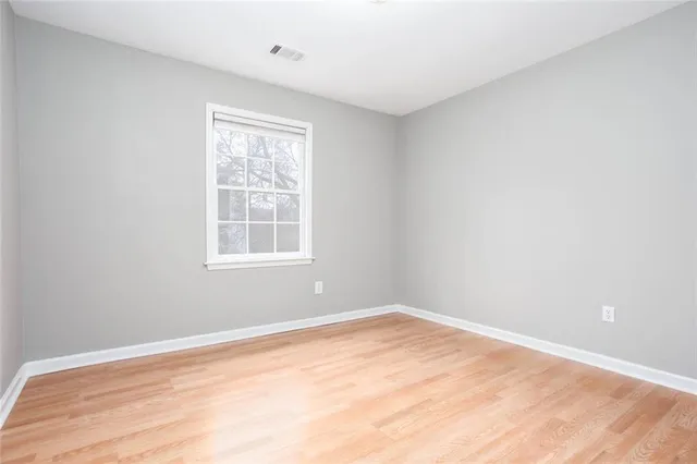a bathroom with a granite countertop sink a toilet and a shower