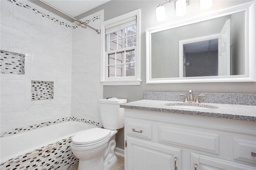 1066 Foreststone Way Marietta, GA 30064 - Photo 34 of 53 a bathroom with a granite countertop sink a toilet and a shower