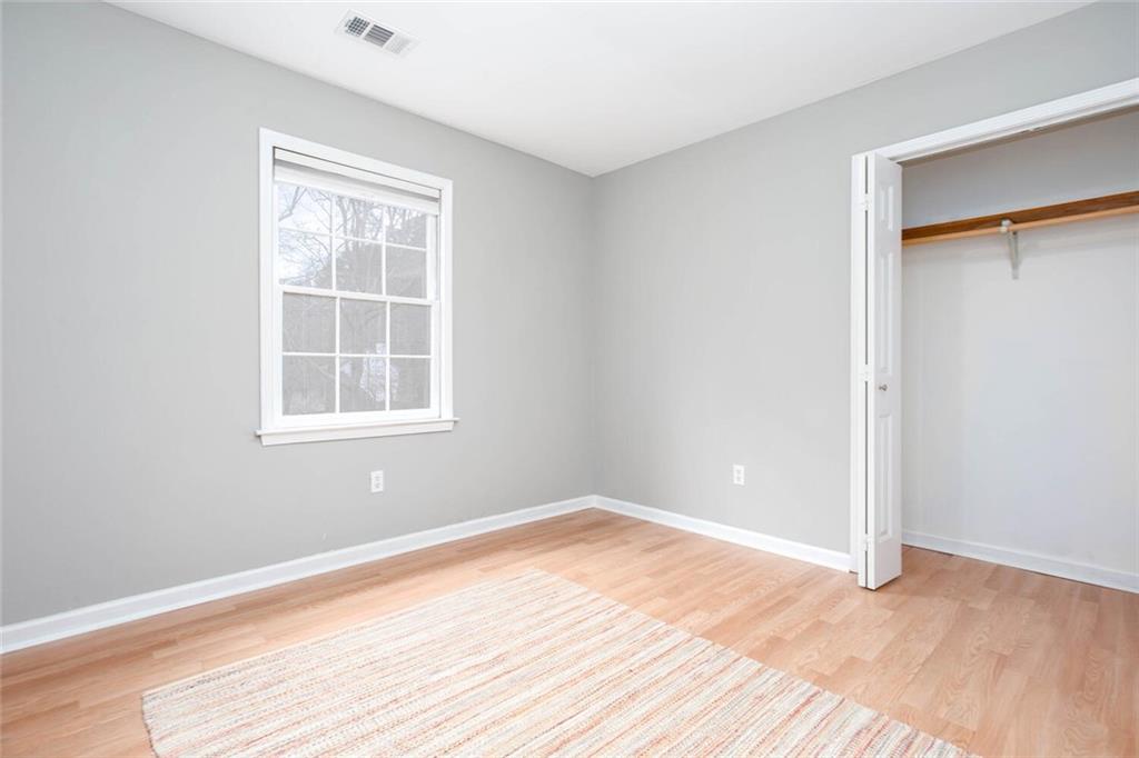 1066 Foreststone Way Marietta, GA 30064 - Photo 38 of 53 an empty room with wooden floor and windows