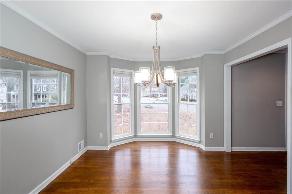 1066 Foreststone Way Marietta, GA 30064 - Photo 4 of 53 a view of an empty room with wooden floor and a window