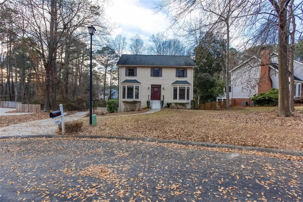 1066 Foreststone Way Marietta, GA 30064 - Photo 53 of 53 a front view of a house with a yard covered with snow and trees
