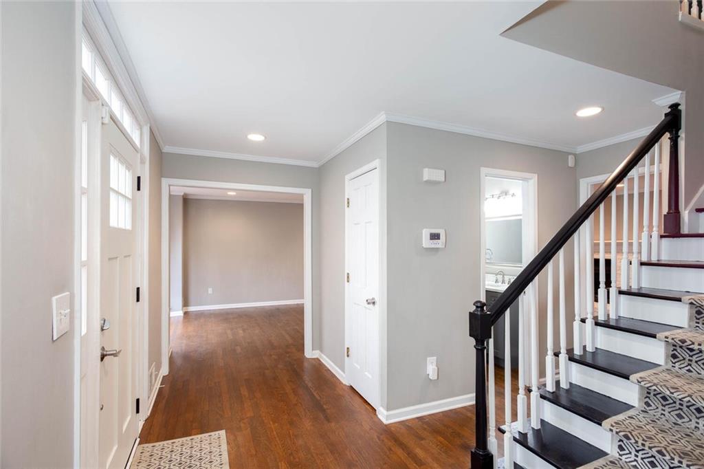 1066 Foreststone Way Marietta, GA 30064 - Photo 7 of 53 a view of a hallway with wooden floor and staircase