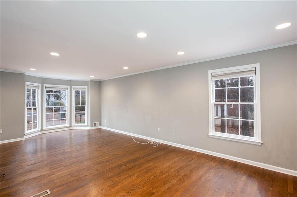 1066 Foreststone Way Marietta, GA 30064 - Photo 9 of 53 a view of an empty room with a window and wooden floor