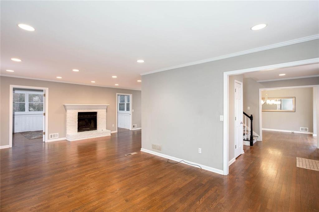 1066 Foreststone Way Marietta, GA 30064 - Photo 10 of 53 a view of an empty room with wooden floor and a fireplace