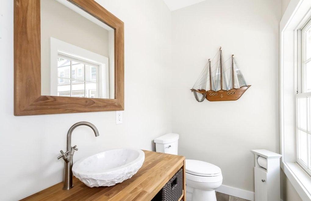 5 Clocks Lane Darien, CT 06820 - Photo 28 of 35 a bathroom with a granite countertop sink a toilet and a mirror