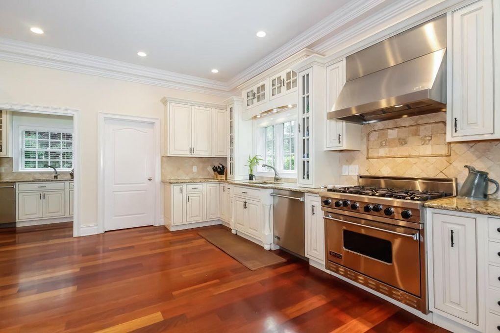 5 Clocks Lane Darien, CT 06820 - Photo 7 of 35 a kitchen with a stove top oven and cabinets