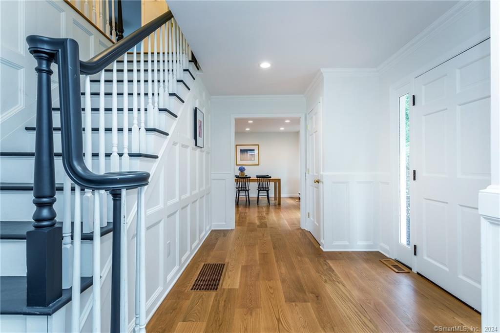 28 Leavenworth Road Woodbury, CT 06798 - Photo 22 of 37 a view of a livingroom with wooden floor and stairs