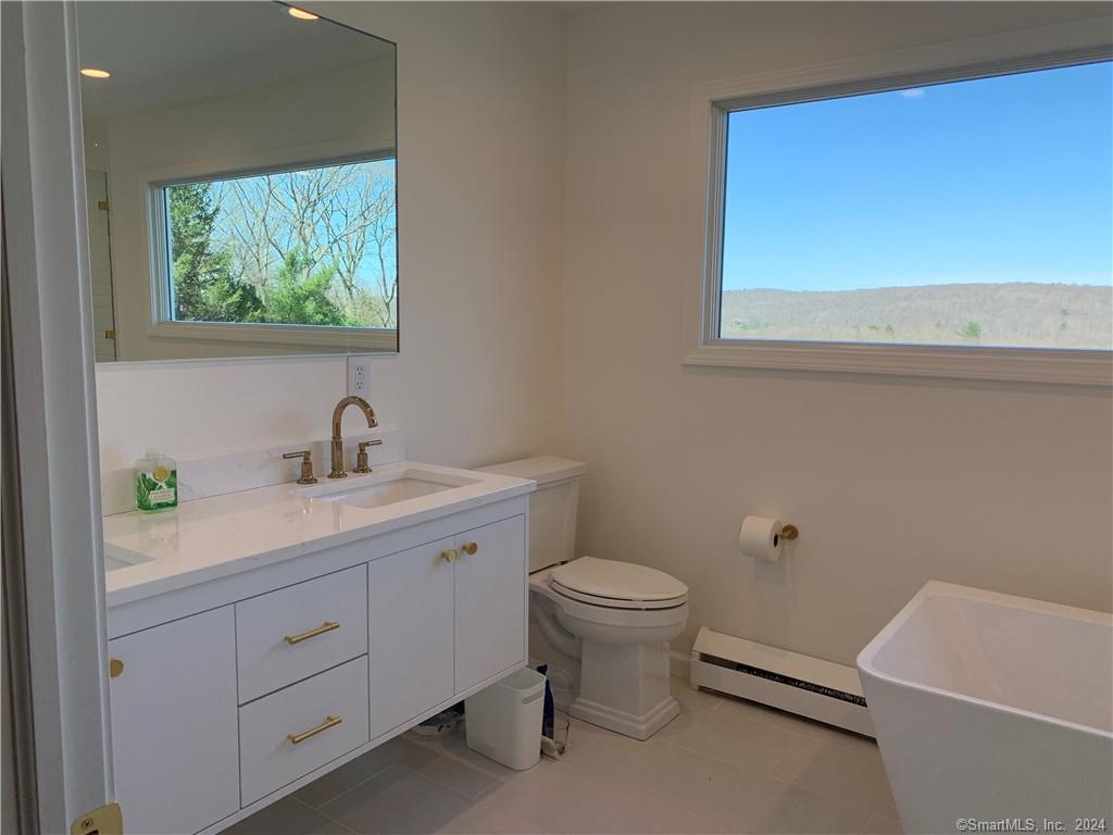 28 Leavenworth Road Woodbury, CT 06798 - Photo 24 of 37 a bathroom with a toilet sink and mirror