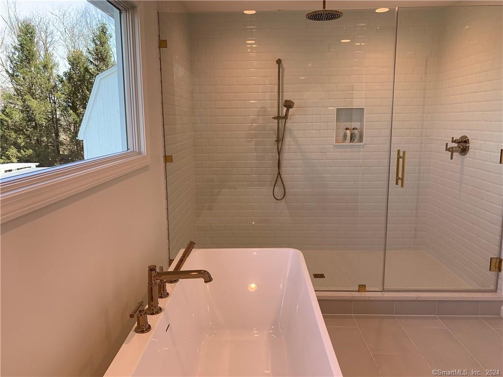 28 Leavenworth Road Woodbury, CT 06798 - Photo 27 of 37 a bathroom with a tub and a shower