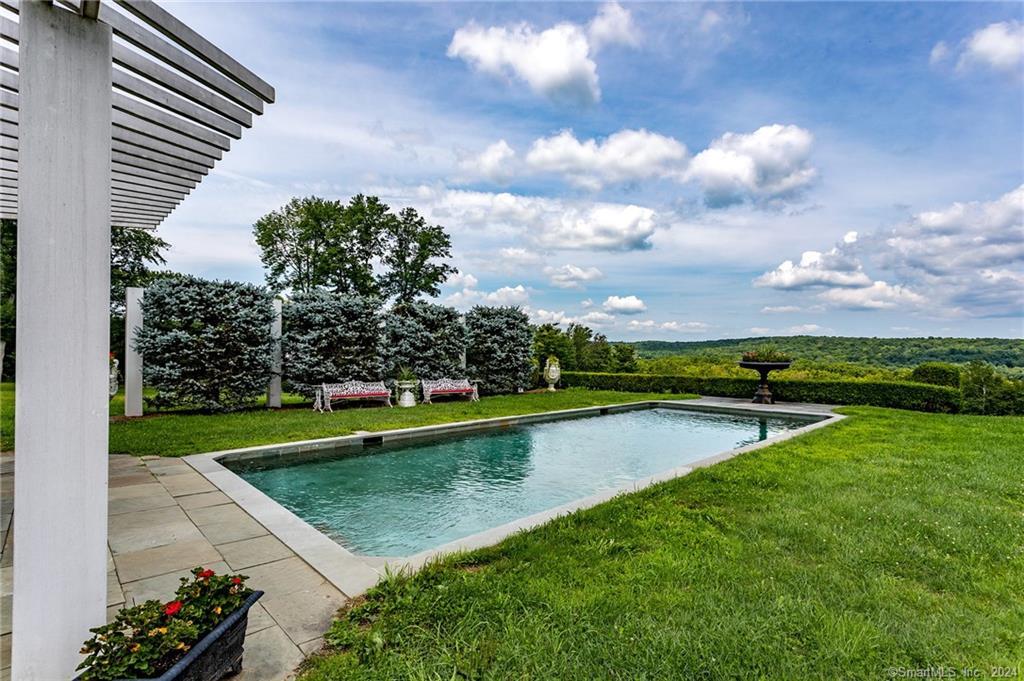 28 Leavenworth Road Woodbury, CT 06798 - Photo 30 of 37 a view of a lake with a swimming pool and outdoor seating