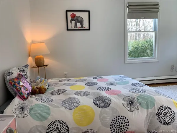 a bedroom with a bed and window