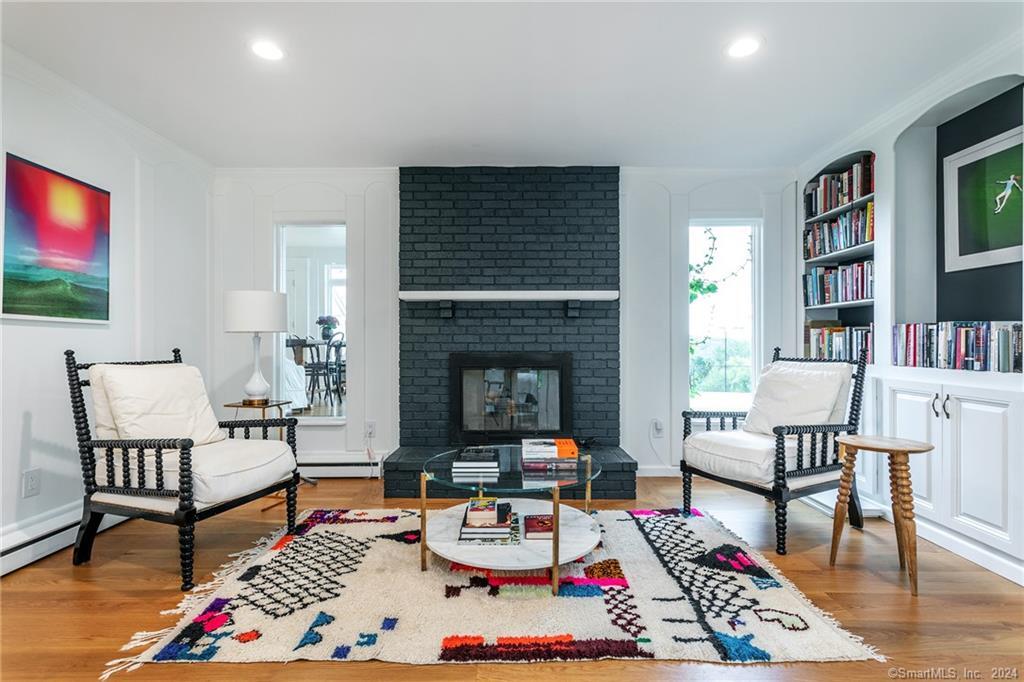 28 Leavenworth Road Woodbury, CT 06798 - Photo 9 of 37 a living room with furniture and a fireplace with bookshelf
