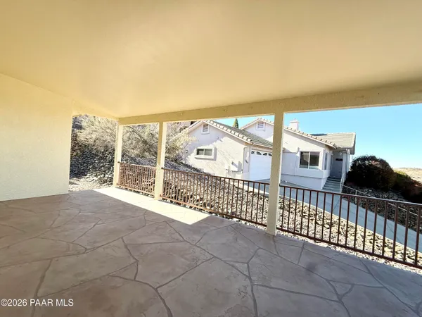 a view of a balcony with iron fence