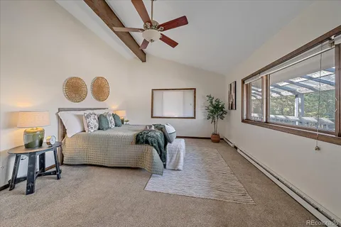 a bedroom with a bed and a painting on the wall