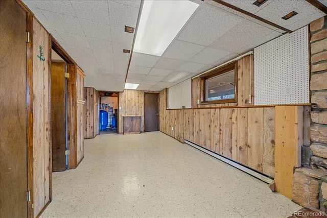 a view of an empty room with a fireplace and a window