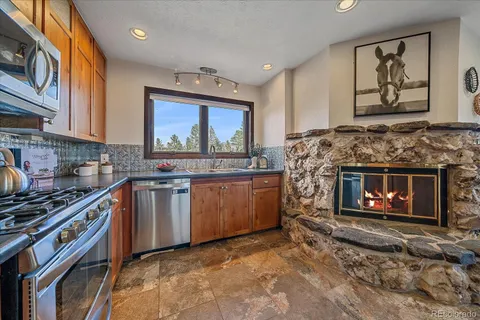 a kitchen with stainless steel appliances a stove top oven and a sink
