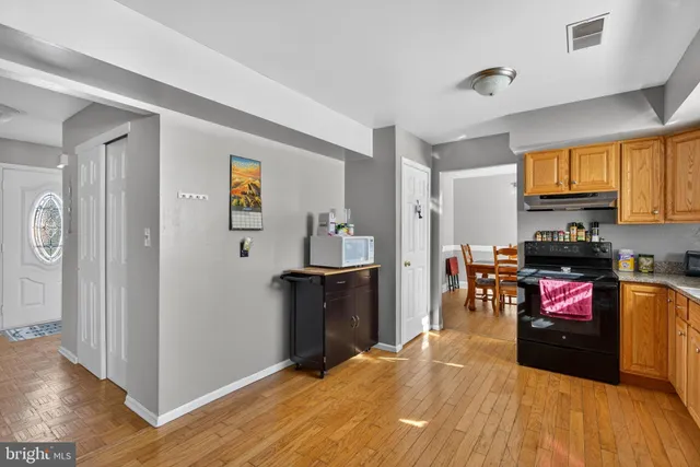 a kitchen with stainless steel appliances a refrigerator and a stove top oven