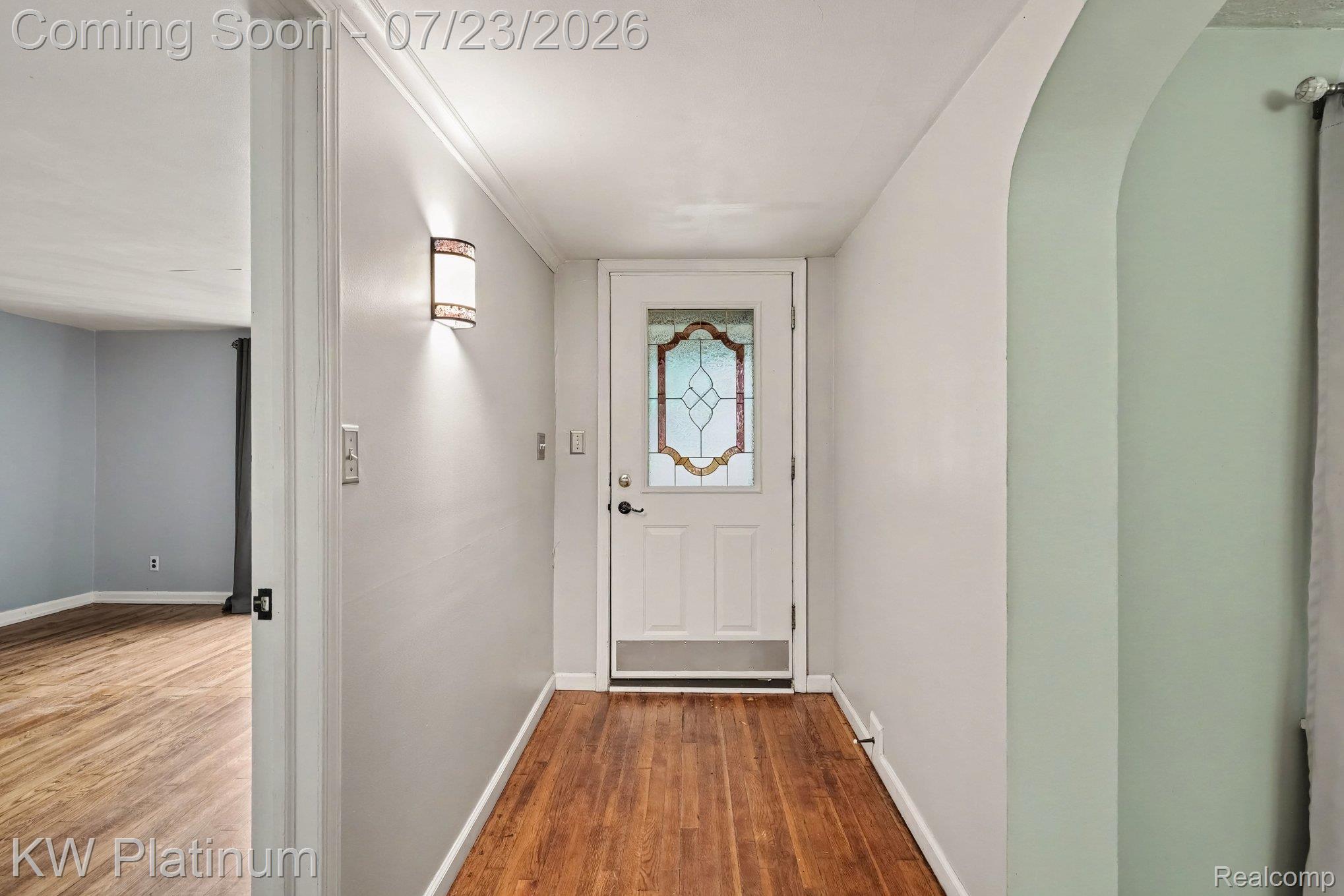 4885 Lakeshore Road Fort Gratiot, MI 48059 - Photo 6 of 26 Entryway featuring wood-finish flooring and a decorative stained-glass front door
