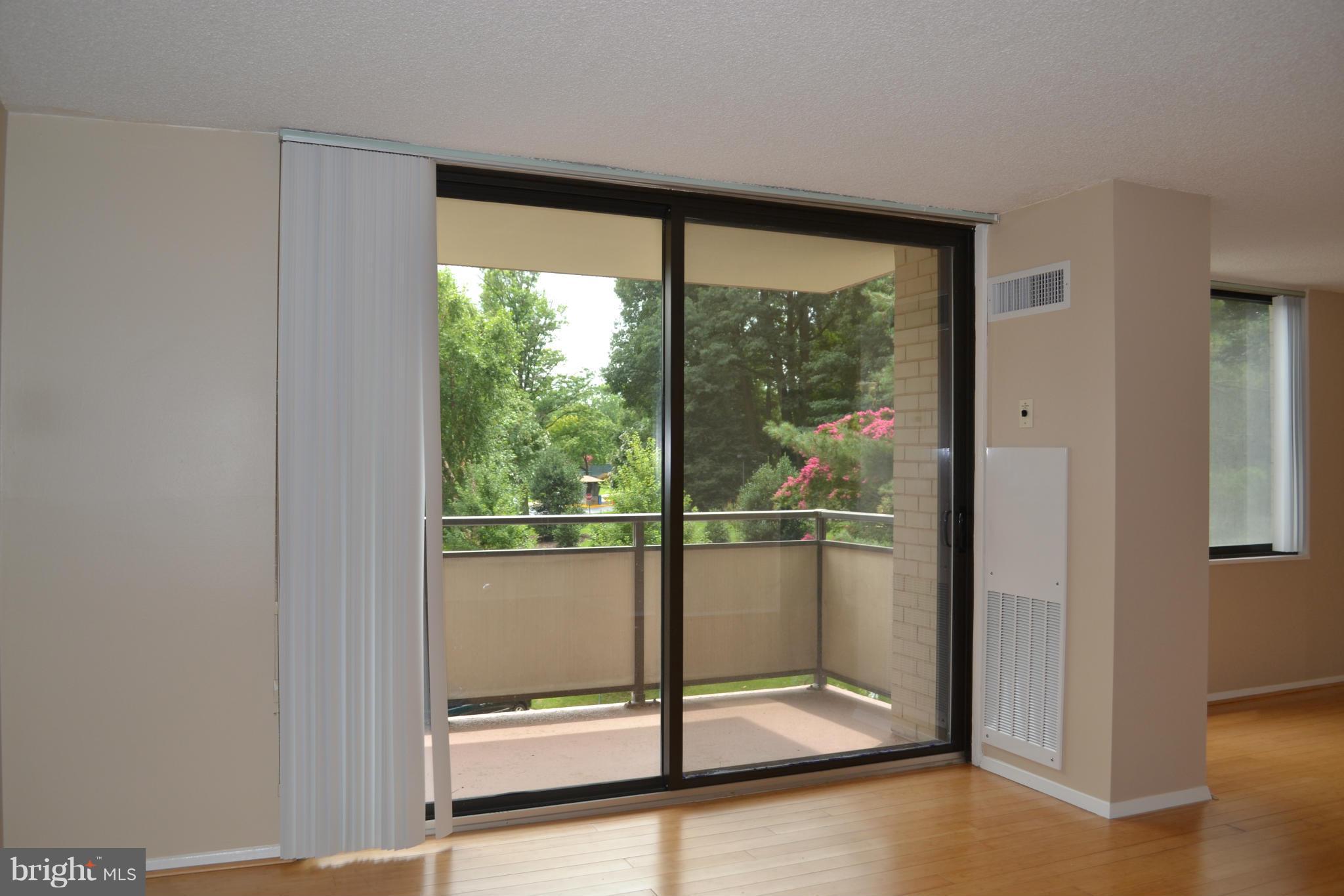 5225 Pooks Hill Road, Unit 204S Bethesda, MD 20814 - Photo 4 of 14 a view of a big room with wooden floor and windows