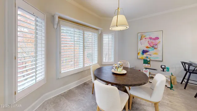 a view of a dining room with furniture and window