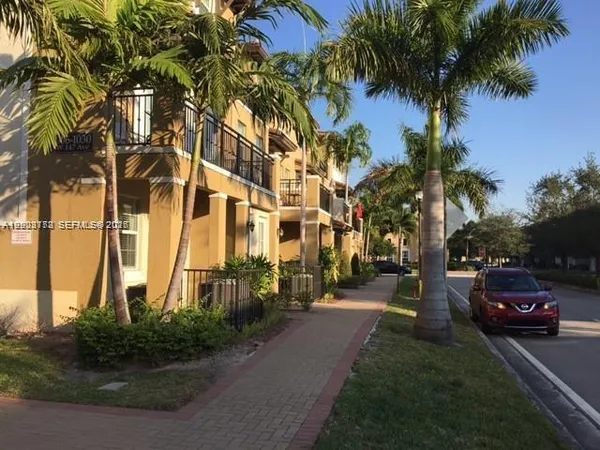 a couple of cars parked in front of a house