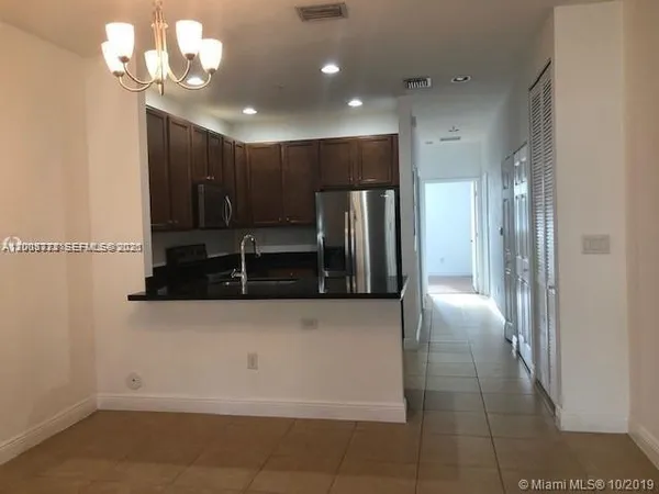 a view of a kitchen with a sink and dishwasher