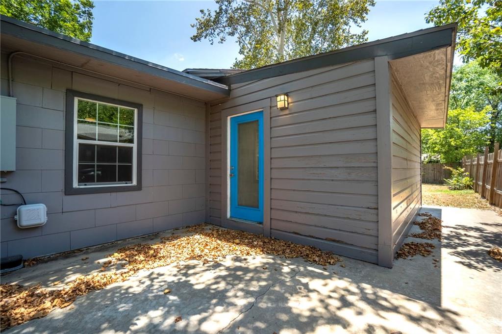 2105 Fortview Road Austin, TX 78704 - Photo 3 of 37 A vibrant blue door offers a welcoming entrance to this modern dwelling.